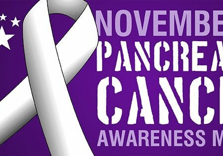 Purple ribbon symbolizing pancreatic cancer awareness month.